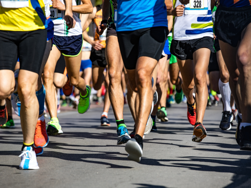 A photgraph taken during a marathon of a group of people's legs running