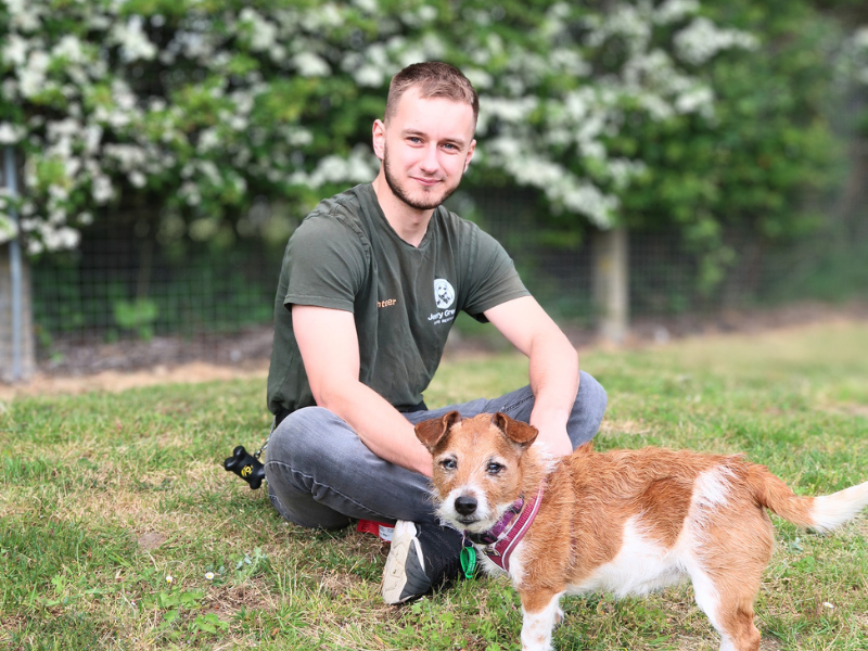 Jerry Green Dog Rescue volunteer sat with a small dog called Lady