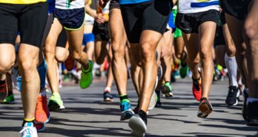 A photgraph taken during a marathon of a group of people's legs running