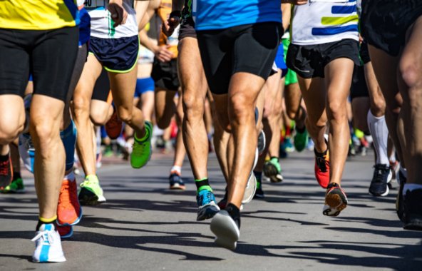 A photgraph taken during a marathon of a group of people's legs running