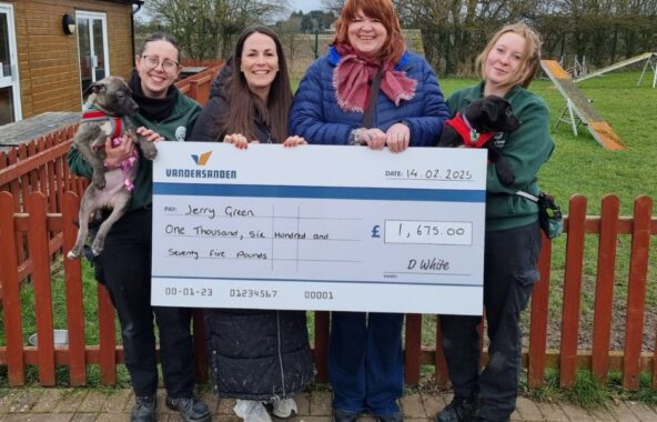 Group of people holding a giant cheque.