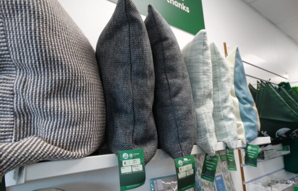 Selection of neutral scatter cushions in a Jerry Green Dog Rescue charity shop