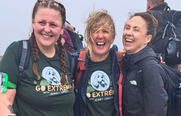 Image of three women on a trek laughing and wearing Go Extreme with Jerry Green t-shirts