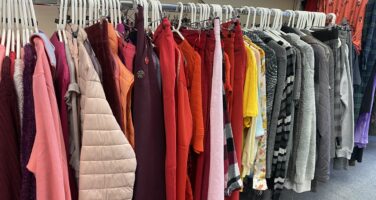 Hanging rail of various coloured garments.