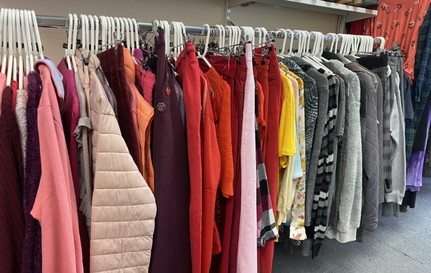 Hanging rail of various coloured garments.