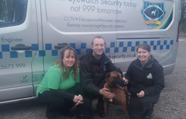 Three people in front of Eyewatch Security Van with a dog