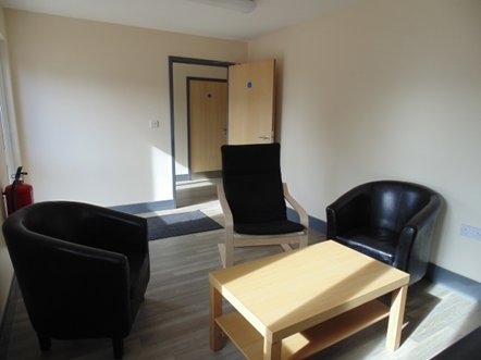 Room with chairs and coffee table.