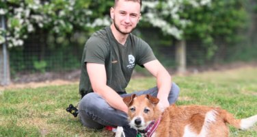Jerry Green Dog Rescue volunteer sat with a small dog called Lady
