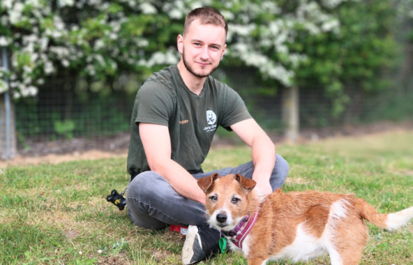 Jerry Green Dog Rescue volunteer sat with a small dog called Lady