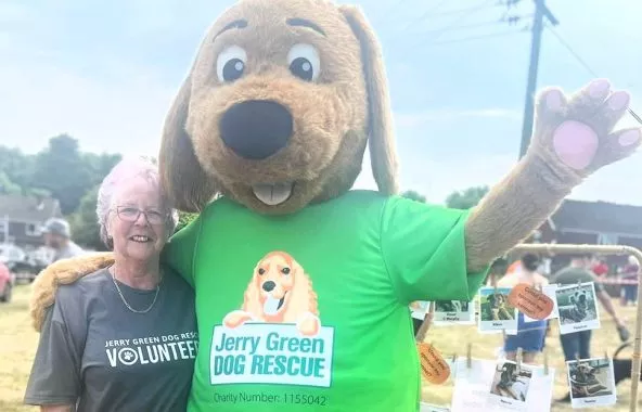 Jerry Green Dog Rescue mascot with volunteer.